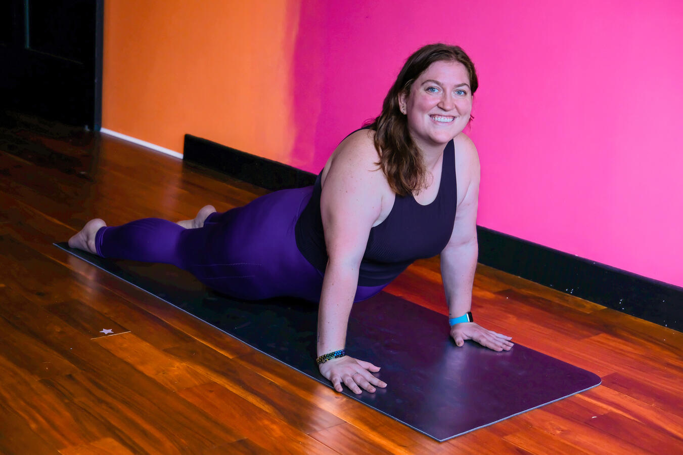Steph on a yoga mat in upward facing dog pose